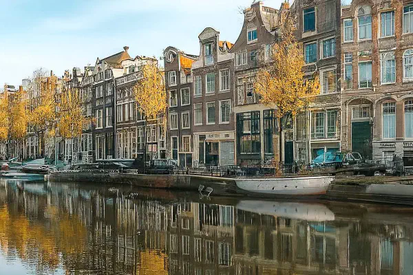 Panoramic view of Amsterdam canals and houses reflecting the housing market